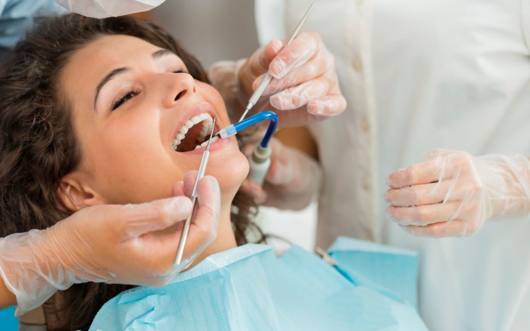 Post-operative care after a tooth extraction includes avoiding spitting, using gauze, and not drinking through a straw. In this image, a woman is being prepared for a dental extraction.